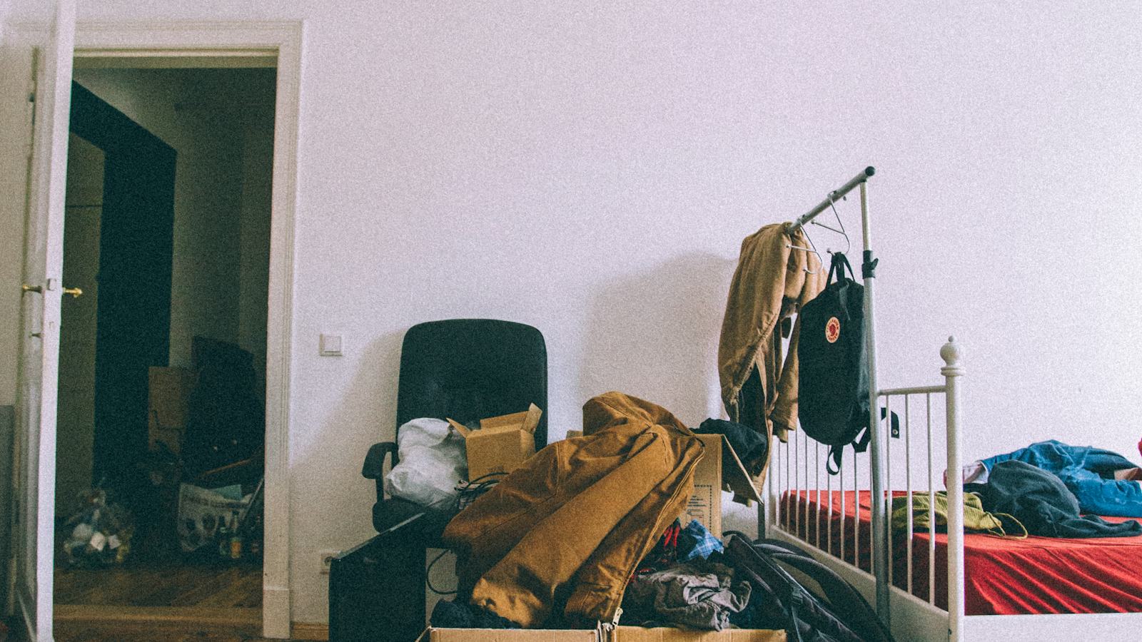 Brown cardboard moving boxes stacked on a wooden parquet floor